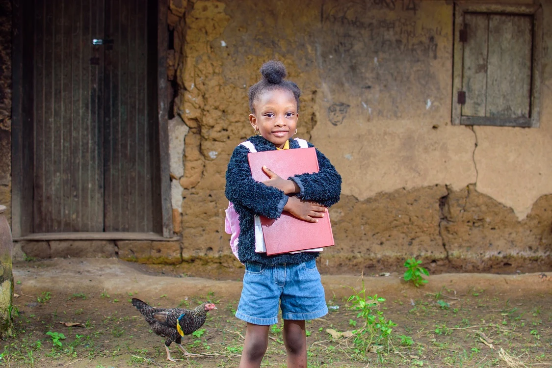 A child holding a notebook, from VCI’s supplied photography